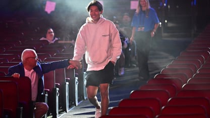 Aidan Park walking to stage at NHL Draft wearing hoodie
