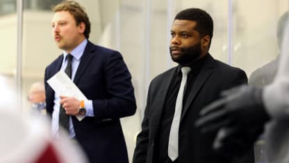 Color of Hockey Zack Dailey climbing coaching ladder with MacEwan University